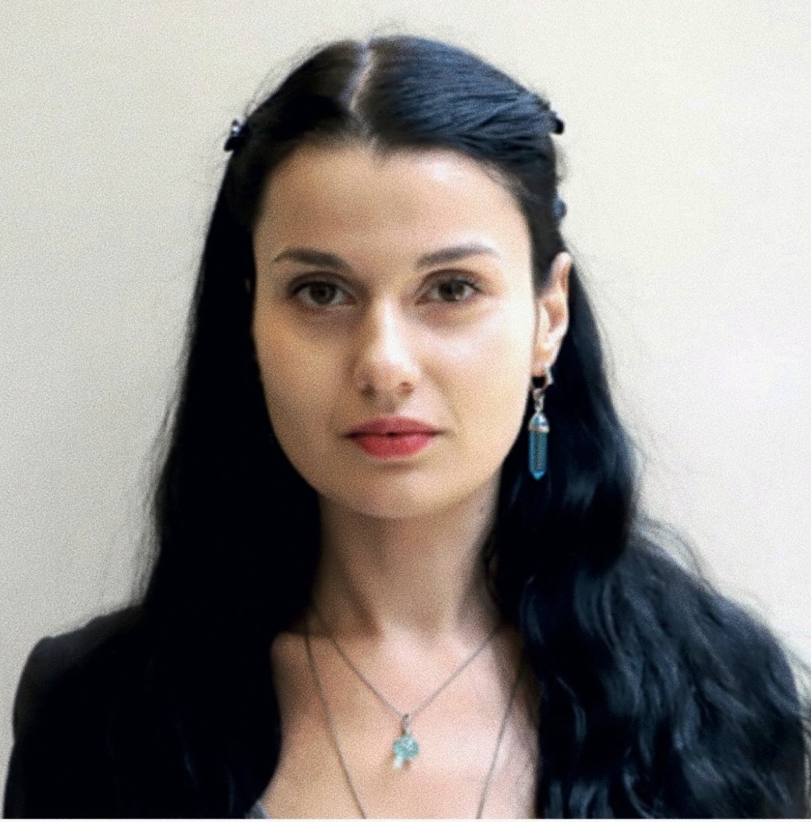 Yoni is a young white women, with very long black hair and a single long earing